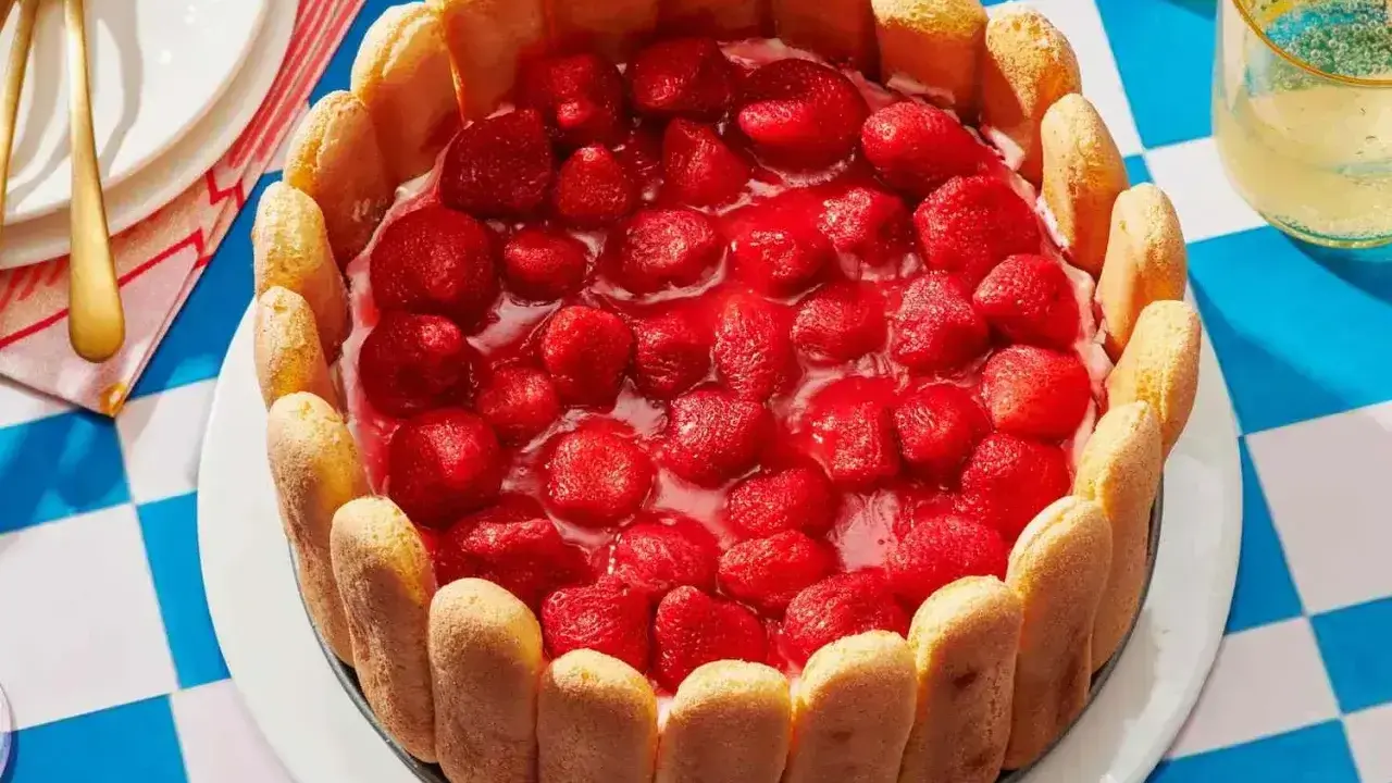 Pyszny deser z truskawkami, otoczony biszkoptami. Idealny na letnie popołudnie.