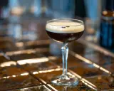 Idealny espresso martini przepis na orzeźwiający drink. Ciemny napój z pianką w kieliszku.
