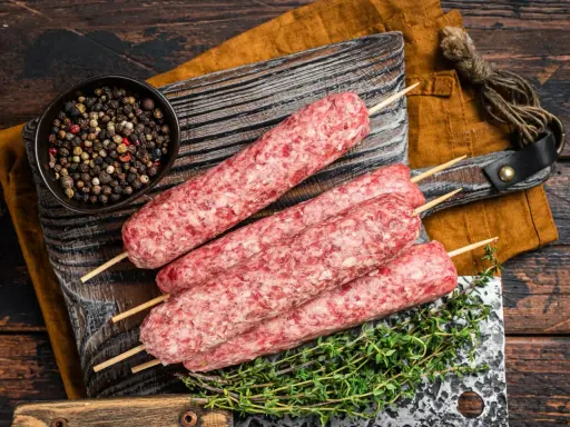 Surowe kebaby na patyczkach, miseczka pieprzu i tymianek. Idealne składniki na kofta libańska przepis.