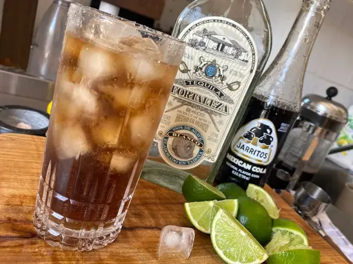 Orzeźwiający drink: tequila z colą, lodem i limonką. Idealny na gorące dni.