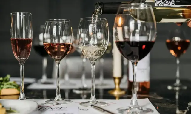 Degustacja win: nalewanie białego wina do kieliszka. Zastanawiasz się nad wino białe kcal? Różowe i czerwone wina też są w zestawie.